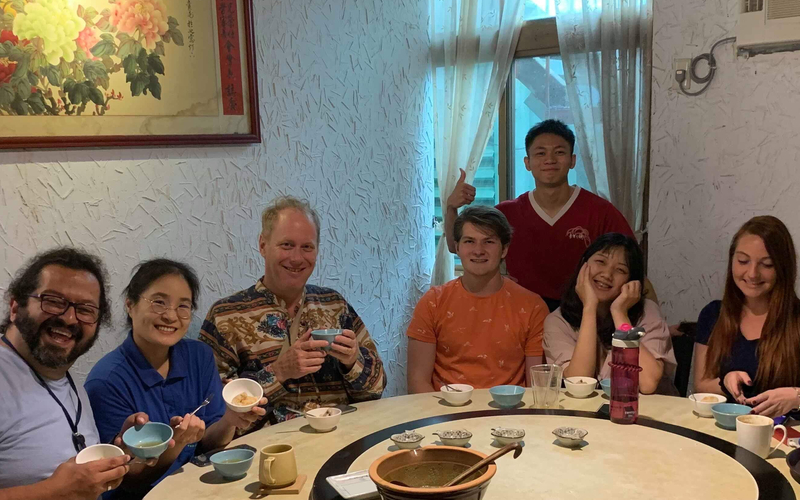 Students and professors at a dinner table