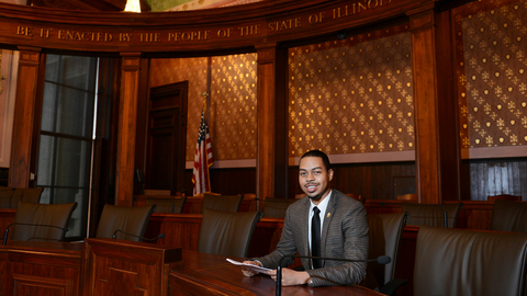 a UIS student sitting on the house floor of the Illinois State Capitol