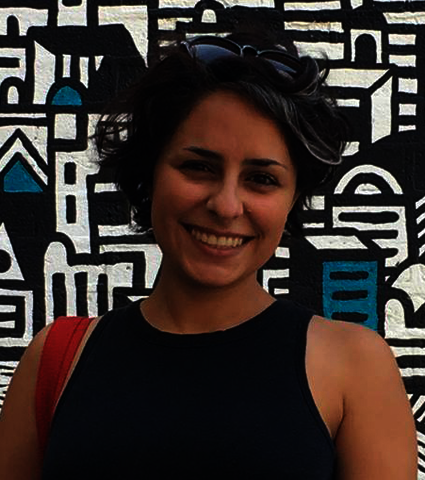 Naghmeh Farzaneh standing in front of artwork