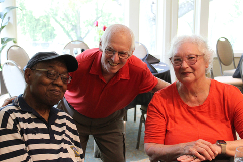 Three people pose for a photo together