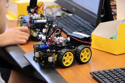 a robotic vehicle being programmed at a computer