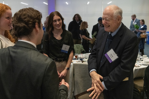 Charlie Wheeler laughs with former students