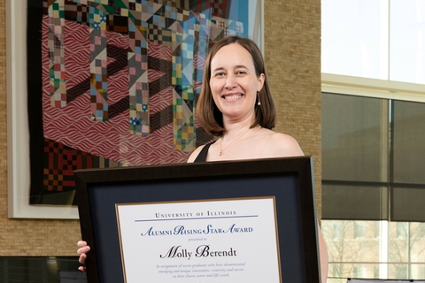 Molly Berendt holding her Alumni Rising Star award