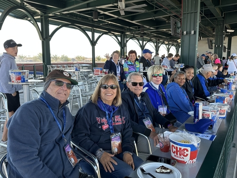 a group of people enjoy a baseball game from a party deck