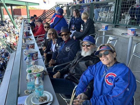 a group of people enjoy a baseball game from a party deck