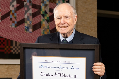Charlie Wheeler holding his Distinguished Service Award