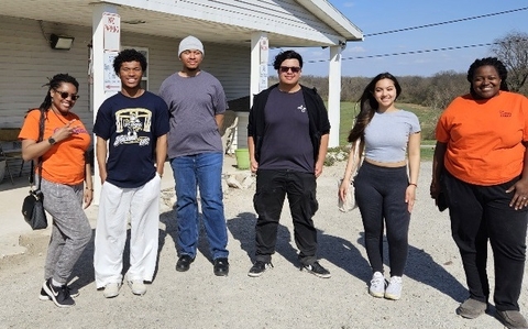 Six Necessary Steps students posing for a photo outside.