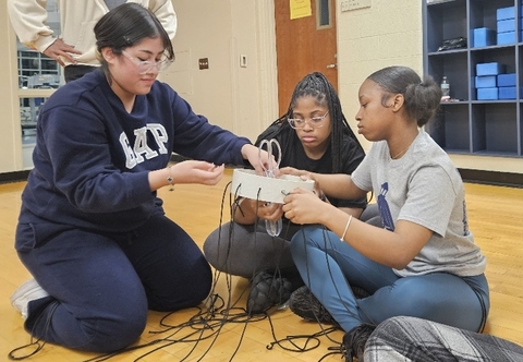 Three students working on a project together.