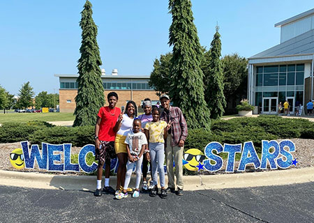 Family of UIS student posing in front of TRAC