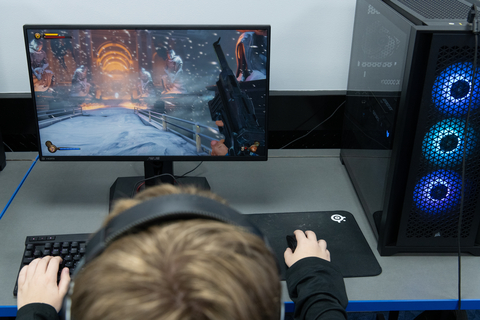 Person sitting at a computer in the UIS Esports Arena playing a game
