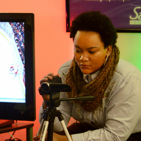 a student filming with a camcorder for the Visual Storytelling class