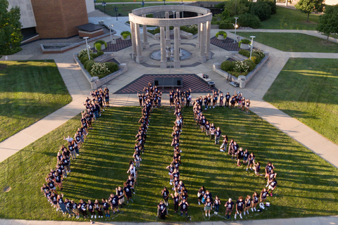 overhead shot of people spelling out UIS on the quad in front of the colonnade