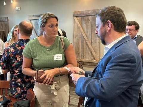 two people talk at a UIS Professionals Network event