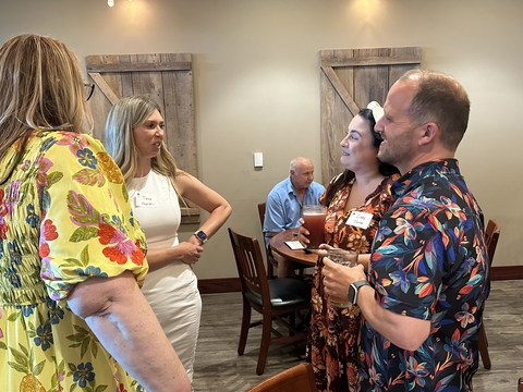four people chat at a UIS Professionals Network event