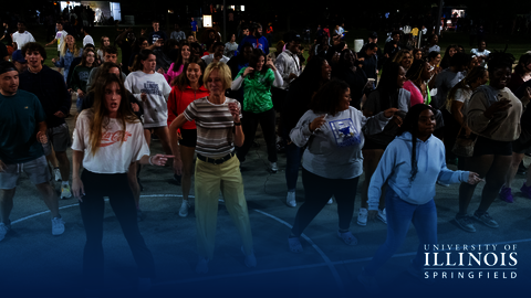 Chancellor Gooch dances with a crowd of students at RecPalooza.