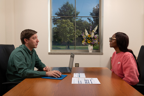 A financial advisor talking with a student.