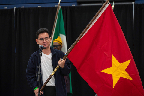 Student holds a flag representing his country at annual International Festival