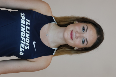student posed in front of a beige background with Illinois Springfield team jersey.