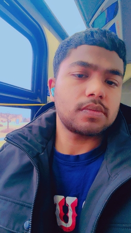 student posed with a royal blue shirt and navy blue jacket.