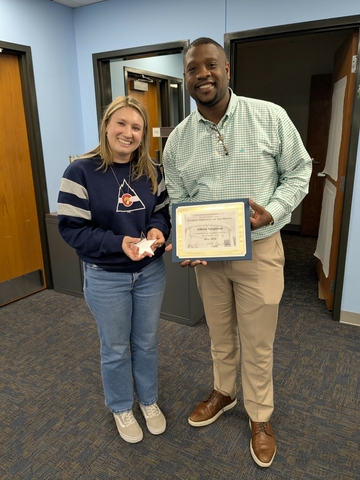 Allison Sarginson receiving award from Dr. J for Employee of the Month.
