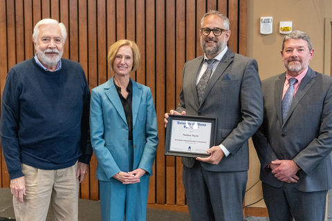 Burks Oakley II, Chancellor Gooch, Nathan Steele holding framed award, and Provost Schwab.