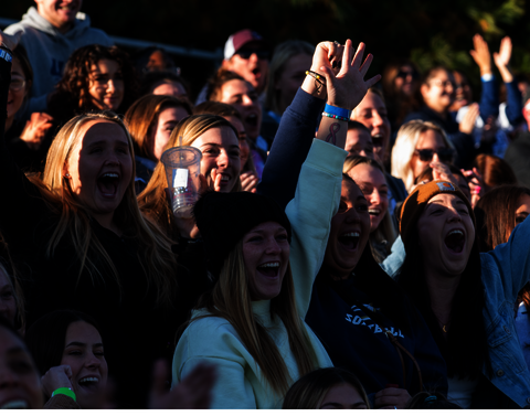 Students cheering at a sporting event.