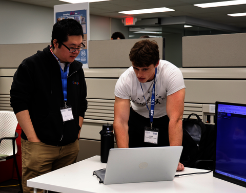 Two students looking at a laptop.
