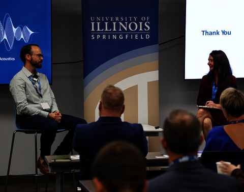 A man being interviewed at a UIS conference.