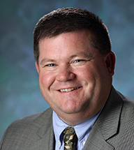 Headshot of Gregory Knott.