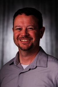 Headshot of Adam Hill.
