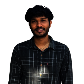 Smiling male student with black hair and a black beard wearing a button down shirt with white stripes.