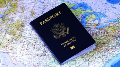 USA passport laying over a map of the USA