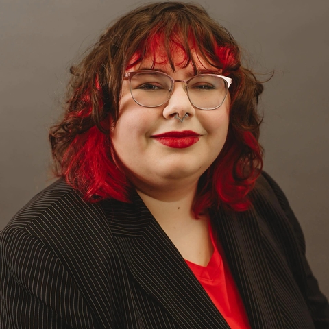 student posed in front of brown background