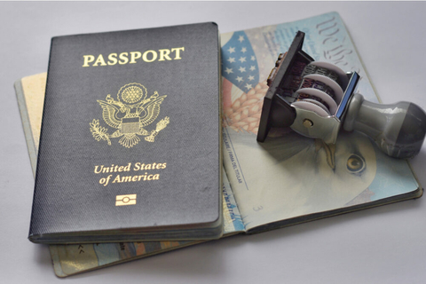 US Passport on top of an open US passport with an entry date stamp
