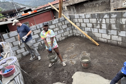 UIS students mix and pour cement by hand while building a home in a Guatemalan village.