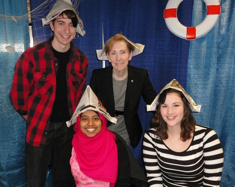 A group of people wearing hats made out of newspaper.