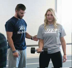 students lifting weights