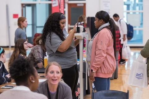 student weighing another student