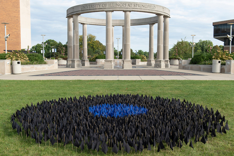 Colonnade with wrongfully convicted person flags planted in the ground near it