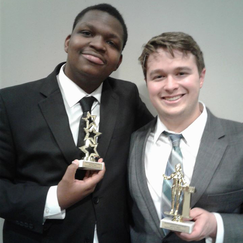 Cedric Birgins and Joseph Partain holding awards
