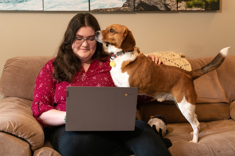student Kara Torres in her home with dog Beaux