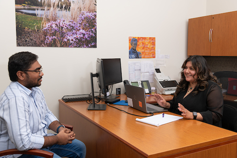 A student talking to a financial aid advisor.