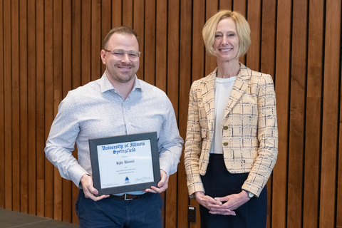 Kyle Blount with Chancellor Gooch and Kyle's framed certificate for the 2025 Early Career Scholarship Award.