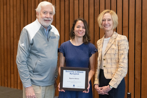 Tia Bolivar with Chancellor Gooch, Burks Oakley, and Tia's framed certificate for the 2025 Oakley Distinguished Online Teaching Award.