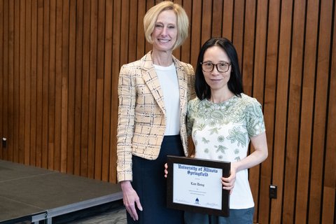 Lan Dong with Chancellor Gooch and Lan's framed certificate for the 2025 Spencer Faculty Service Award.