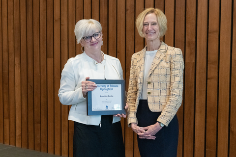 Jennifer Martin with Chancellor Gooch and Jennifer's framed certificate for the 2025 Faculty Engagement Award