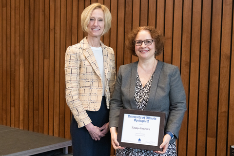 Natalya Zinkevich with Chancellor Gooch and Natalya's framed certificate for the 2025 Pearson Faculty Award.
