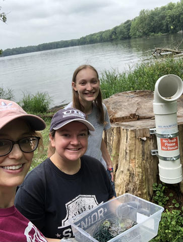 people collecting trash at the lake