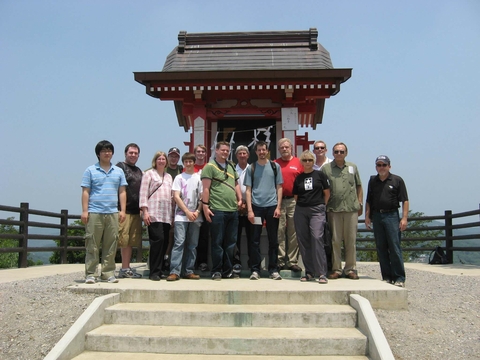 professors and students posing in front of a traditional Japanese patio