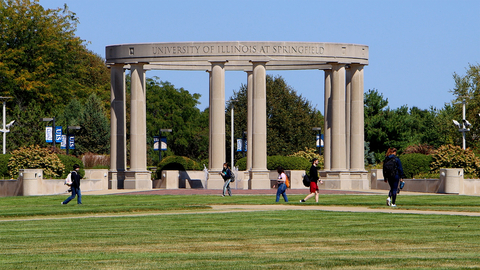 students walking on the quad with the colonnade in the background